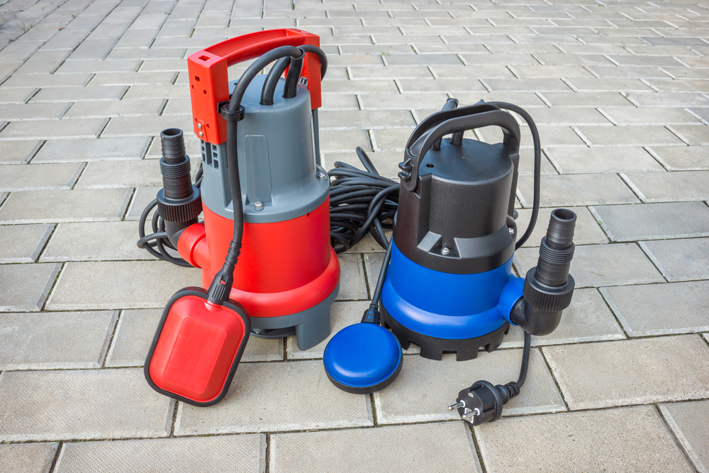 Two,Household,Submersible,Pump,With,Plastic,Housings,On,Stone,Floor